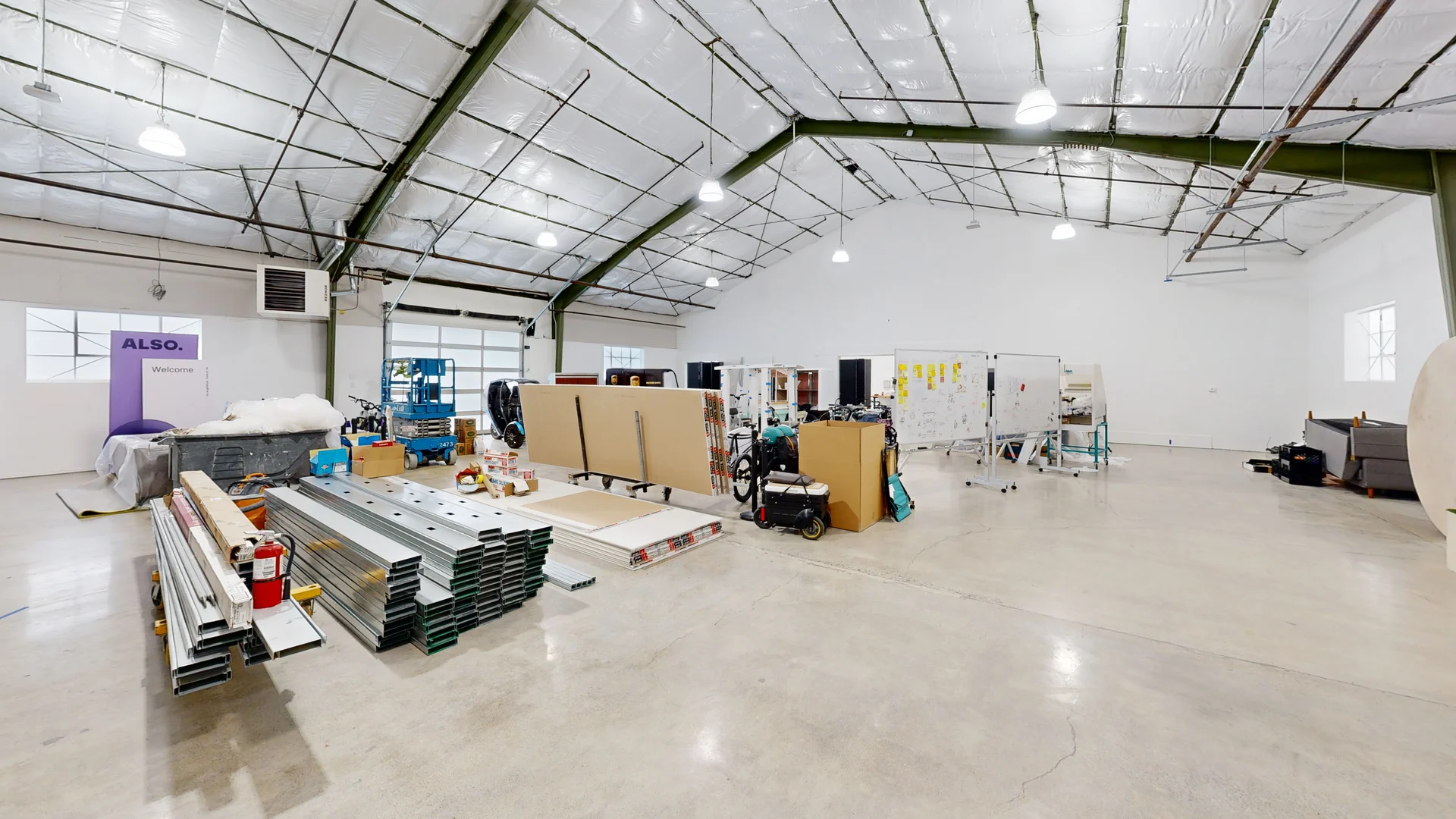 Commercial interior showing roof structure, equipment and open floor area